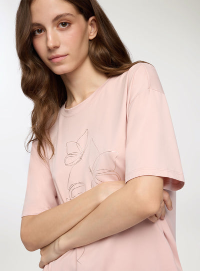 T-shirt con stampa volto e farfalle