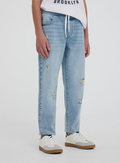 Jogger in denim con strappi e coulisse