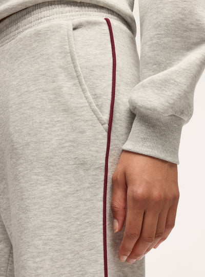 Pantaloni tuta wide leg con piping laterale
