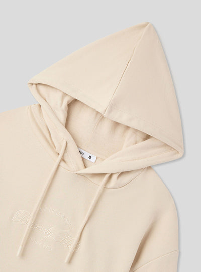 Felpa crop con cappuccio e scritta ricamata
