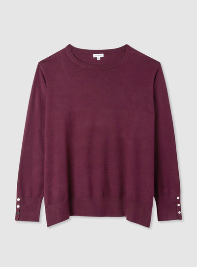 Pull uni avec boutons aux poignets
