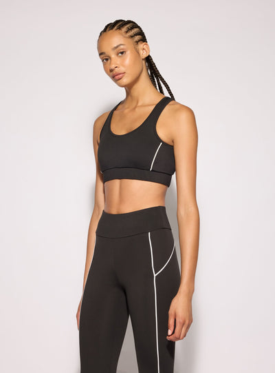 Top sportivo con retro incrociato e piping