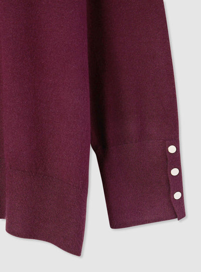 Pull uni avec boutons aux poignets