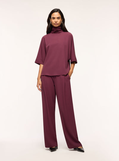 Blusa con collo alto e maniche 3/4