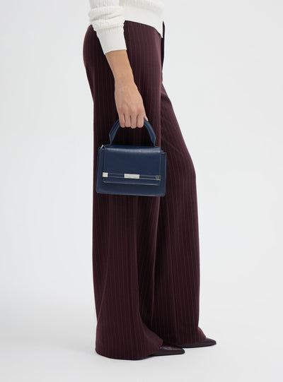 Borsa mini tinta unita con manico e tracolla regolabile