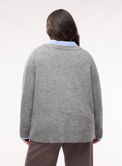 Plain-coloured top with V-neck and side buttons