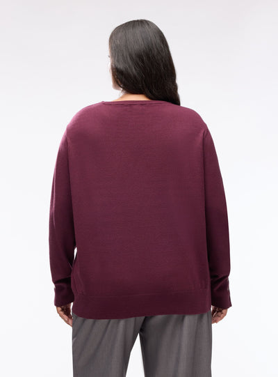 Pull uni avec boutons aux poignets