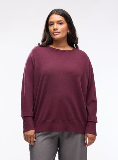 Pull uni avec boutons aux poignets
