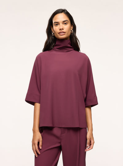 Blusa con collo alto e maniche 3/4