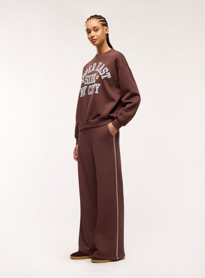 Pantaloni tuta maxi con piping laterale