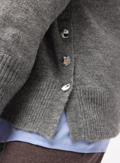Plain-coloured top with V-neck and side buttons