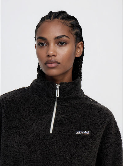 Felpa in sherpa con mezza zip e scritta