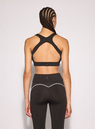 Top sportivo con retro incrociato e piping