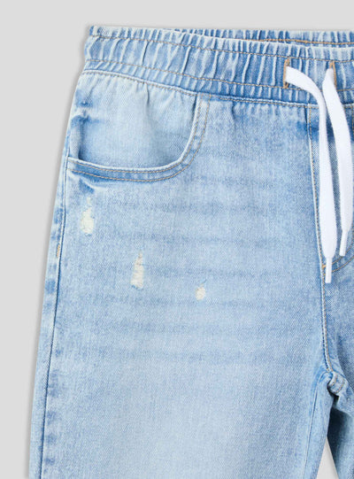 Jogger in denim con strappi e coulisse