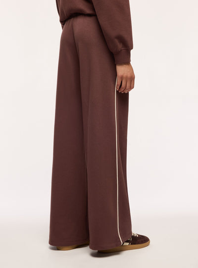 Pantaloni tuta maxi con piping laterale