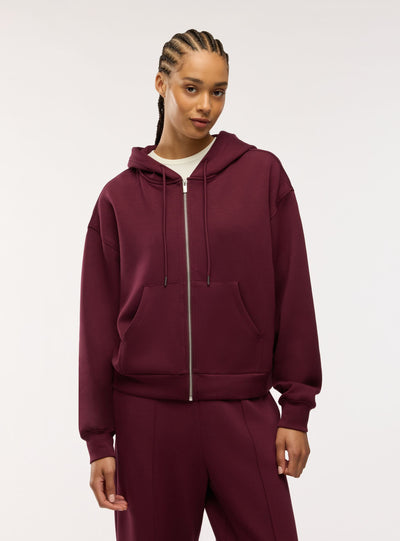 Felpa over con zip e cappuccio a tinta unita