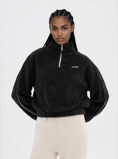 Felpa in sherpa con mezza zip e scritta