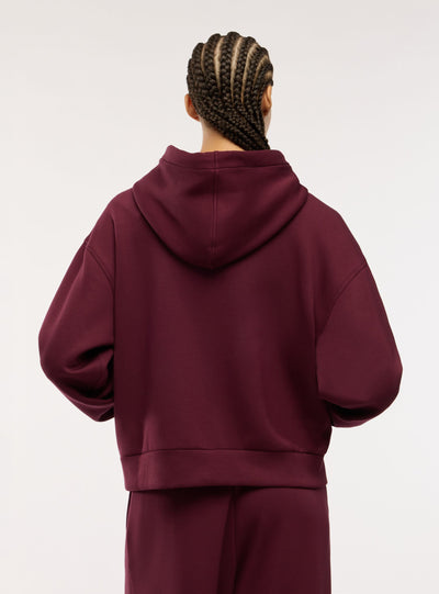 Felpa over con zip e cappuccio a tinta unita
